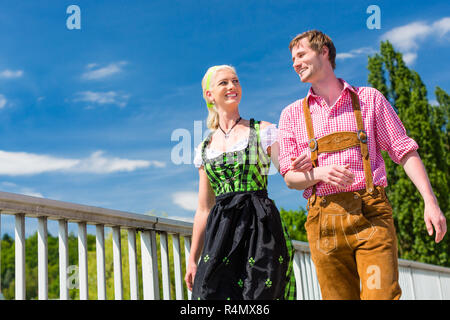 Couple visiting Bavarian fair having fun Stock Photo