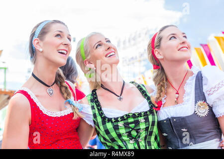 Friends visiting Bavarian folk festival having fun Stock Photo