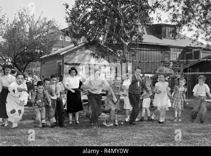 Scene from a classic child's backyard birthday party in California, ca. 1949. Stock Photo