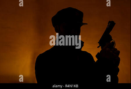 Shadow of a male person holding gun in his hands Stock Photo - Alamy