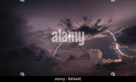 Lightning and storm clouds in sky Stock Photo