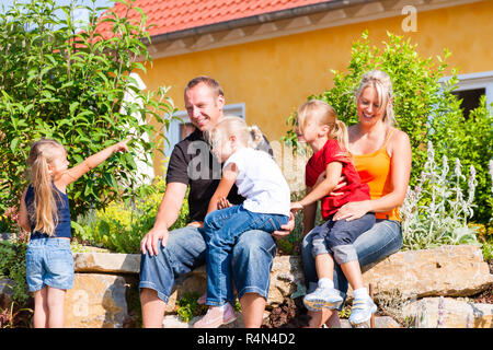 Family in front of home or house Stock Photo