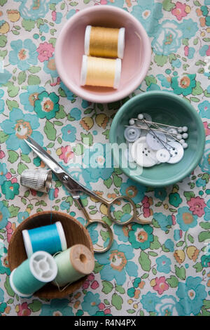 Spools of thread, scissors, and buttons Stock Photo