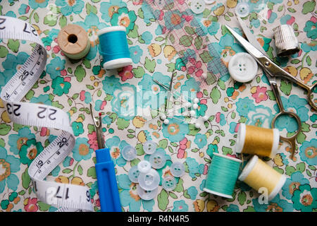 Spools of thread, seam ripper, and measuring tape Stock Photo