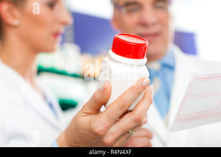 Two pharmacists in pharmacy consulting Stock Photo