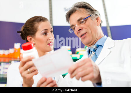 Two pharmacists in pharmacy consulting Stock Photo