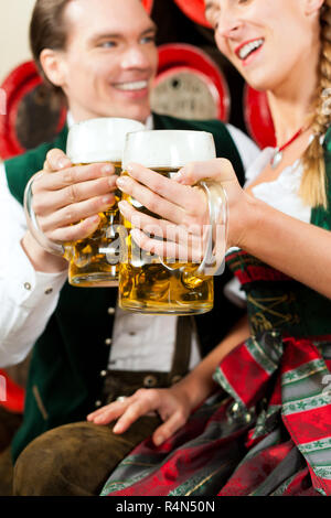 Couple drinking beer in brewery Stock Photo