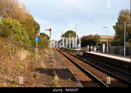 Oulton Broad North Railway Station, Suffolk, Looking east showing an unused and weed bound platform. Stock Photo