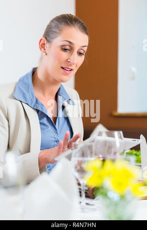 Business woman with tablet in restaurant