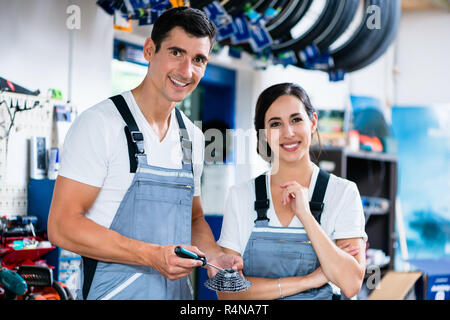 Woman and man as bike mechanics in workshop Stock Photo