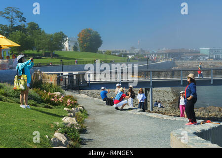 Asian tourists taking pictures in front of Frenchman Bay, Bar Harbor, Maine, USA. Stock Photo