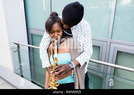 African couple playing Saxophone Stock Photo