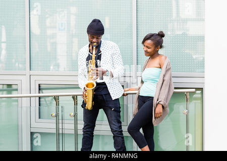 African couple playing Saxophone Stock Photo