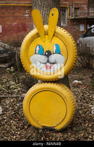 Yellow hare made from waste tyres on the child's playground in Ivanovo, Russia. ATTENTION: This image is a part of a photo essay of 18 photos featuring the same playground. Stock Photo