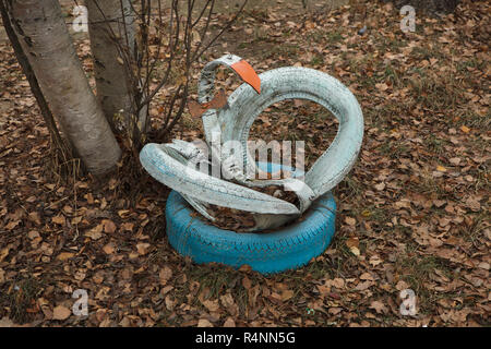 Swan made from waste tyres on the child's playground in Ivanovo, Russia. ATTENTION: This image is a part of a photo essay of 18 photos featuring the same playground. Stock Photo