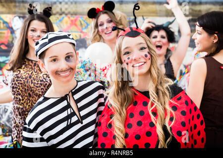 Boy and girl dresses as ladybird and prisoner at German fastnacht carnival procession Stock Photo