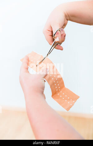 In First aid class, Cutting of patch for smaller lesions Stock Photo