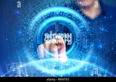 Business, Technology, Internet and network concept. Young businessman working on a virtual screen of the future and sees the inscription: Network secu Stock Photo