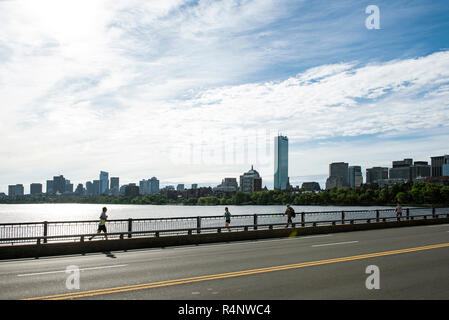 Side view of people running and walking on bridge on Charles River, Boston, Massachusetts, USA