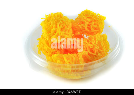 golden egg yolks threads isolated thai desserts on bowl on white background / name in thai Foi Thong yellow egg yolks threads Stock Photo
