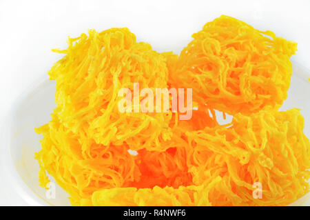 golden egg yolks threads isolated thai desserts on bowl on white background / name in thai Foi Thong yellow egg yolks threads Stock Photo