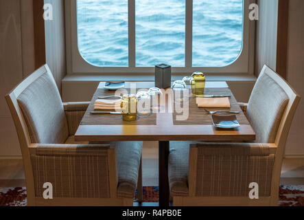 Table for two in shipboard restaurant by window Stock Photo