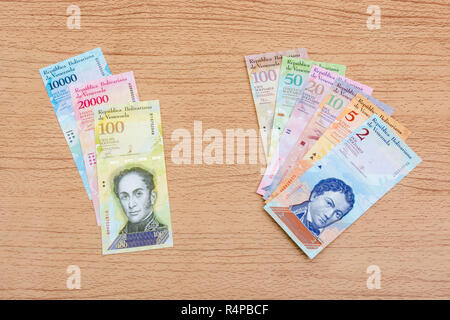 Venezuela Bolivar banknotes on faux wood b/gd - for Hyperinflation in the Venezuelan economy, where banknotes are almost worthless. SEE ADDIT. NOTES Stock Photo