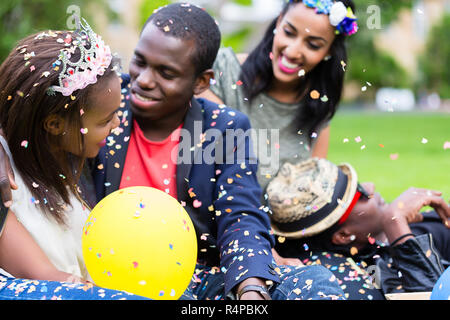 Indian girl and african couple celebrating together on street party Stock Photo