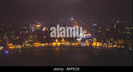 Beautiful super wide-angle night aerial view of Shanghai, China with Waitan, The Bund and scenery beyond the city, seen from the observation deck of O Stock Photo