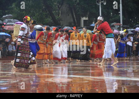 Tribal performers from Rangamati wearing traditional costume and performing a traditional dance at the Central Shaheed Minar in Dhaka on marking the I Stock Photo