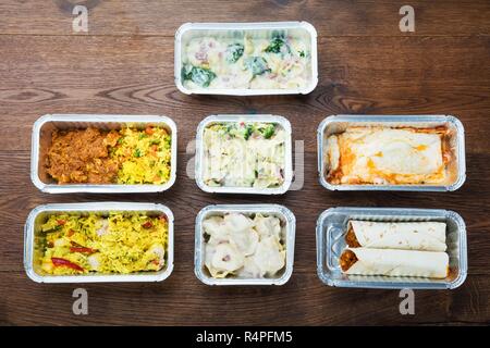 Tasty Meals In Foil Containers On The Table Stock Photo