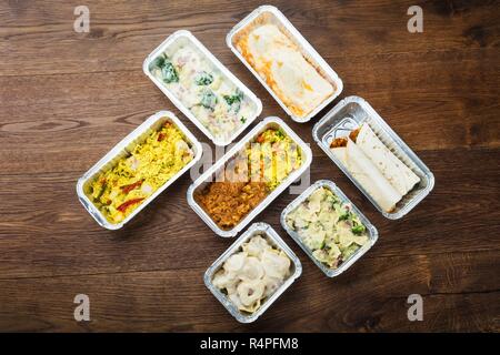 Tasty Meals In Foil Containers On The Table Stock Photo