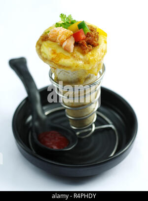 Shrimp cake with chili and herbs on black bowl Stock Photo