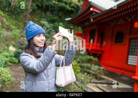 Woman taking photo in Enoshima Stock Photo