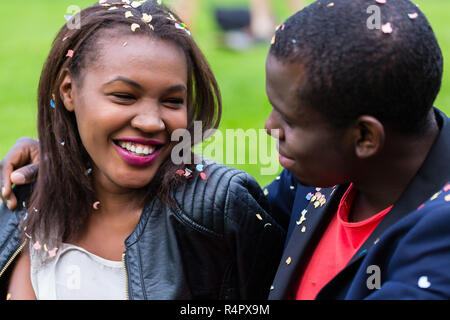 Black couple, woman and man, smiling at each other Stock Photo