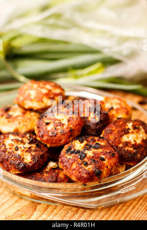 Pike cutlets fried with onion in glass platter Stock Photo