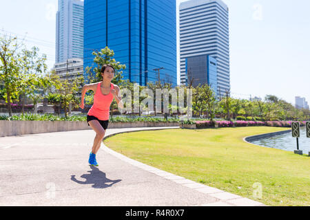 Young Woman running in benjakitti park at bangkok Stock Photo