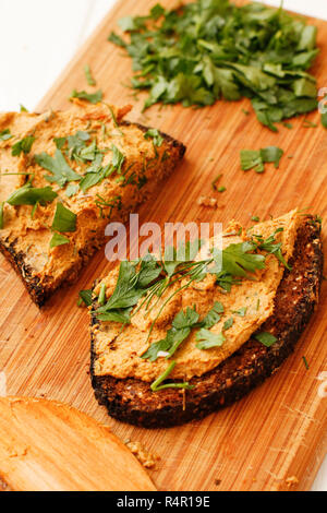 Chanterelle mushroom pate with herbs on wooden board Stock Photo