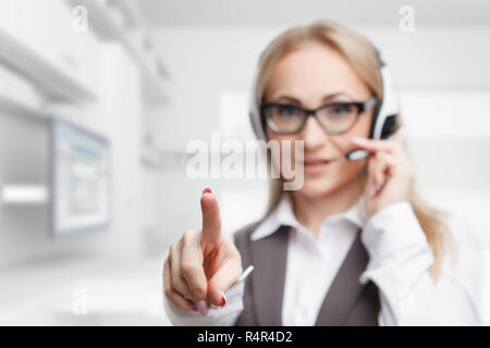Three call center service operators at work. Portrait of smiling pretty female helpdesk employee with headset at workplace. Stock Photo
