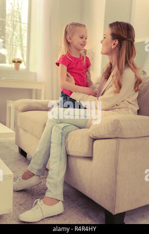 Joyful nice woman sitting on the sofa Stock Photo