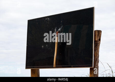 Ax in the TV. The concept of hatred of television, modern technology and talk shows and news. Broken LSD monitor screen Stock Photo