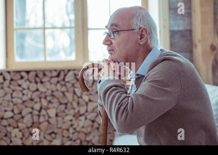 Upset mature man being deep in thoughts Stock Photo