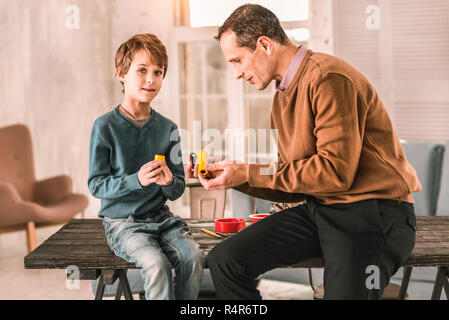 Cute focused child getting distracted from his work for a second. Stock Photo