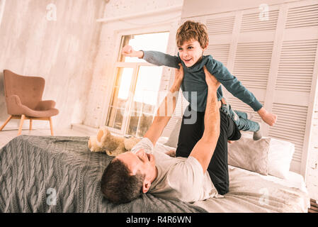 Imaginative ambitious boy dreaming of having special powers. Stock Photo