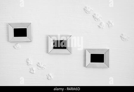 three white wooden photo frames on the wall Stock Photo