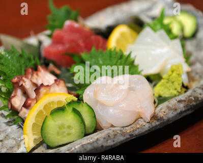 Fresh sashimi of fugu fish with cucumber, lemon and wasabi Stock Photo