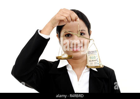 Business woman holding the justice scale- Money saving concept Stock Photo