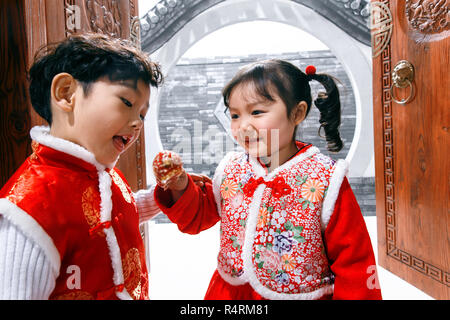 Happy boys and girls eat sugar-coated berry Stock Photo