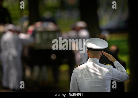 A US Navy Honor Guard conducts a military burial at Arlington National Cemetery in Arlington, VA. Stock Photo