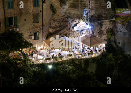 Tropea, Italy - September 06, 2016: People visit restaurant on the cliff in small town in southern Italy by night Stock Photo